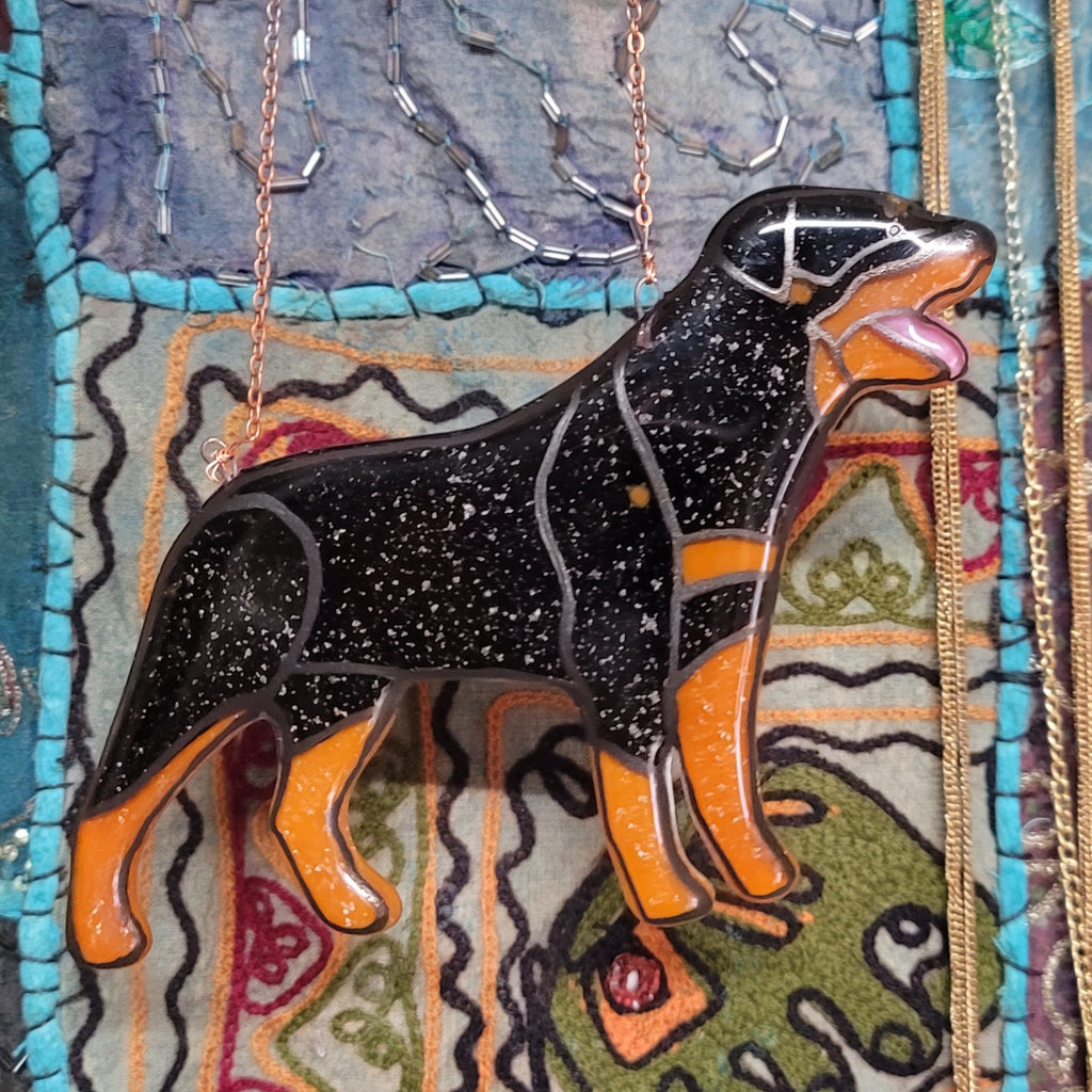 Rottweiler Glass Urn Ashes-Infused-Glass Ornament   A glass cremation urn suncatcher with a silhouette of a Rottweiler dog with cremation ashes inside. infusion glass artist Joele Williams ashes infused glass