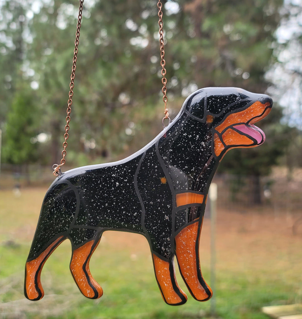 Rottweiler Glass Urn Ashes-Infused-Glass Ornament   A glass cremation urn suncatcher with a silhouette of a Rottweiler dog with cremation ashes inside. infusion glass artist Joele Williams ashes infused glass