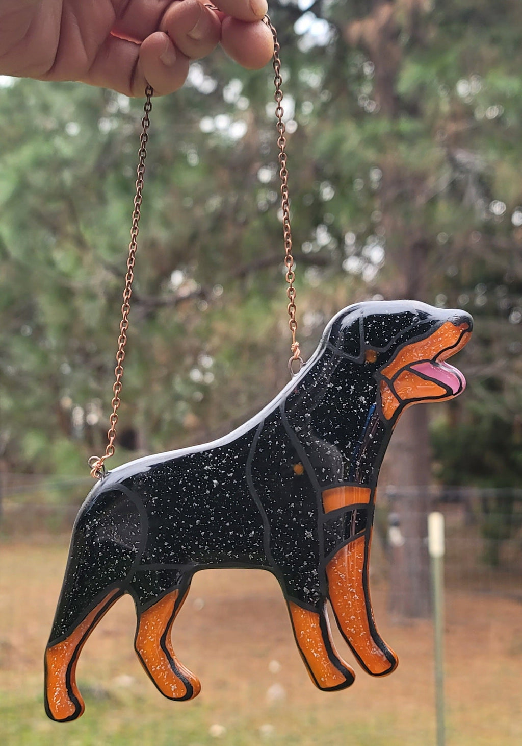 Rottweiler Glass Urn Ashes-Infused-Glass Ornament   A glass cremation urn suncatcher with a silhouette of a Rottweiler dog with cremation ashes inside. infusion glass artist Joele Williams ashes infused glass