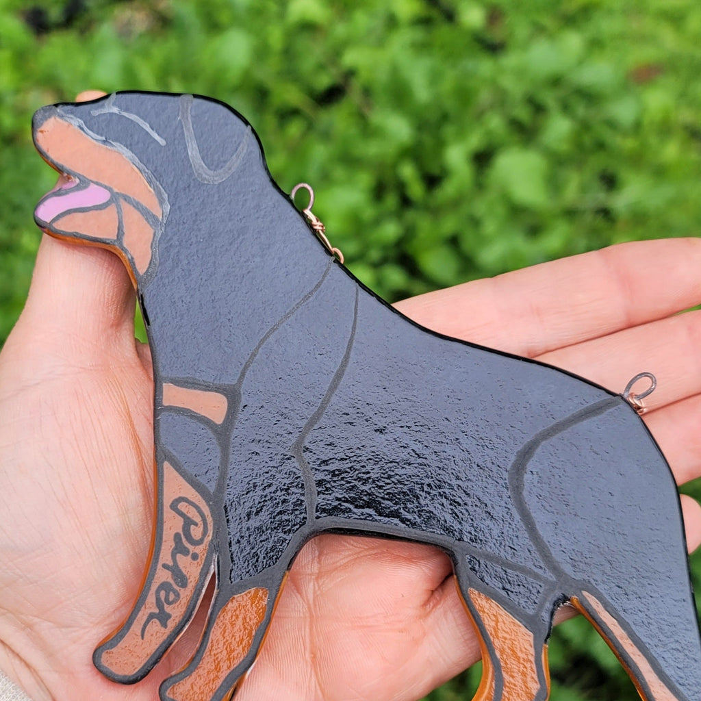 Rottweiler Glass Urn Ashes-Infused-Glass Ornament  the back of  A glass cremation urn suncatcher with a silhouette of a Rottweiler dog  showing the pets name . cremation ashes inside. infusion glass artist Joele Williams ashes infused glass