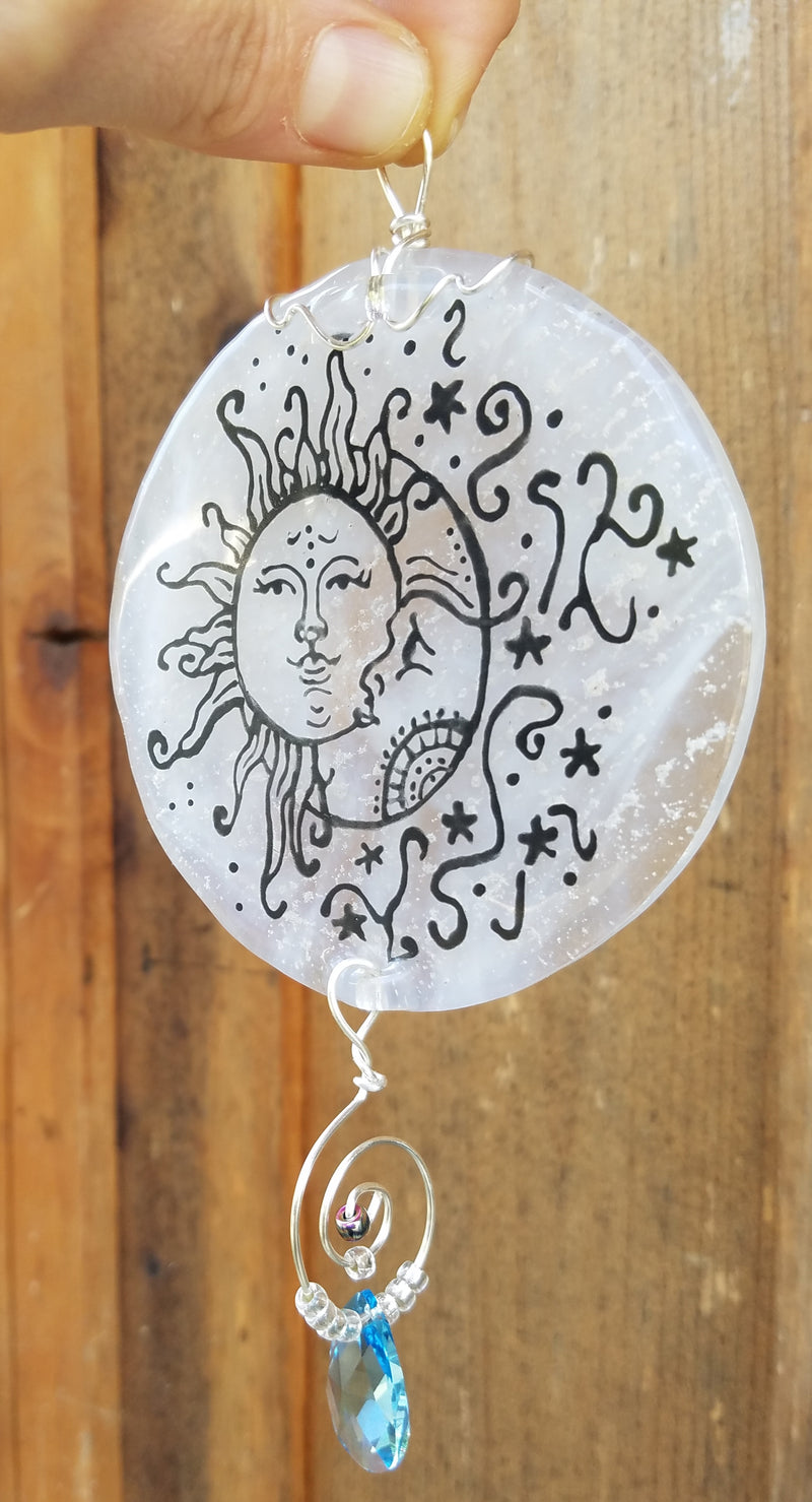 moon and sun suncatchr outside Celebration of life Funeral Memorials. Ashes in Glass Cremation Glass Art Sculptures, Cremation Wind Chimes, Cremation Sun Catchers, Table Displays, & Cremation Jewelry Custom USA Handmade by Infusion Glass. Ashes Infused Glass Human and Pet Cremation Ash Urns  Ashesinfusedglass.com