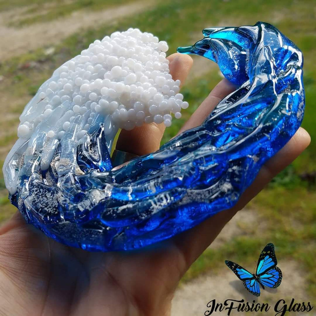 hand holding 5 inch 3d glass ocean wave cremation memorial glass ashes infused glass by infusion glass 