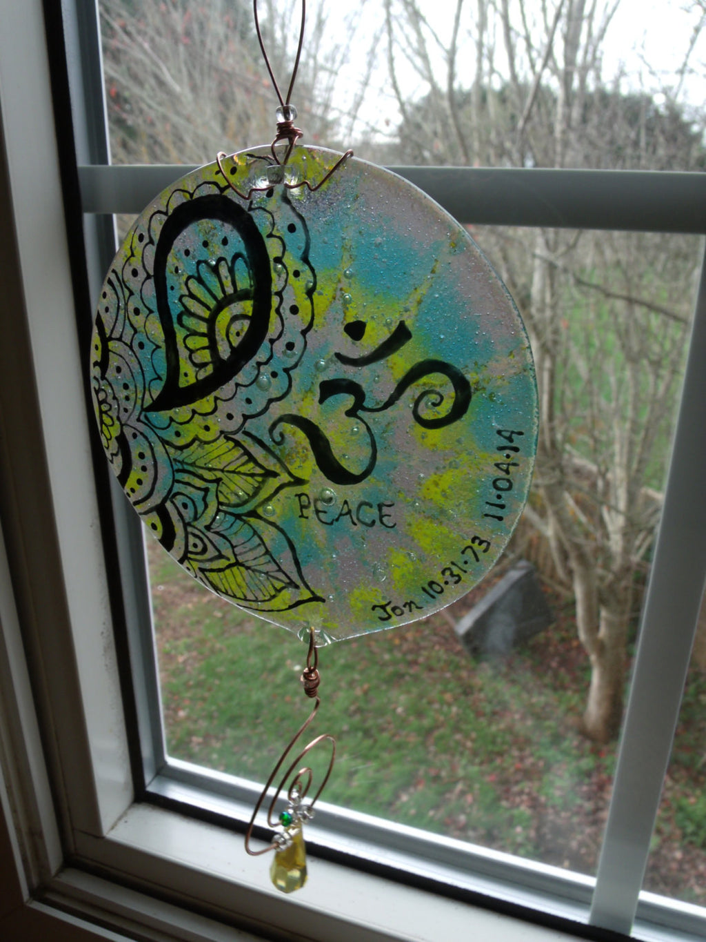 Ashes Infused Glass Cremation Art Sun Catcher OM Peace Memorial in a window